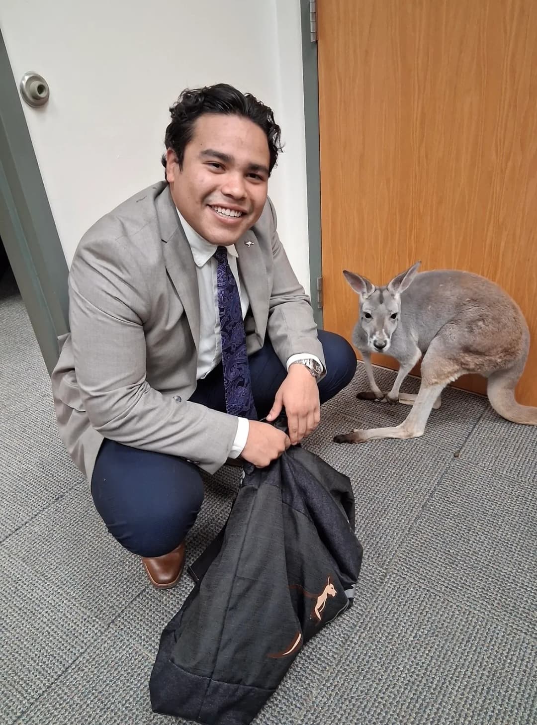 Diego Carvajal with Sophie the kangaroo at the office