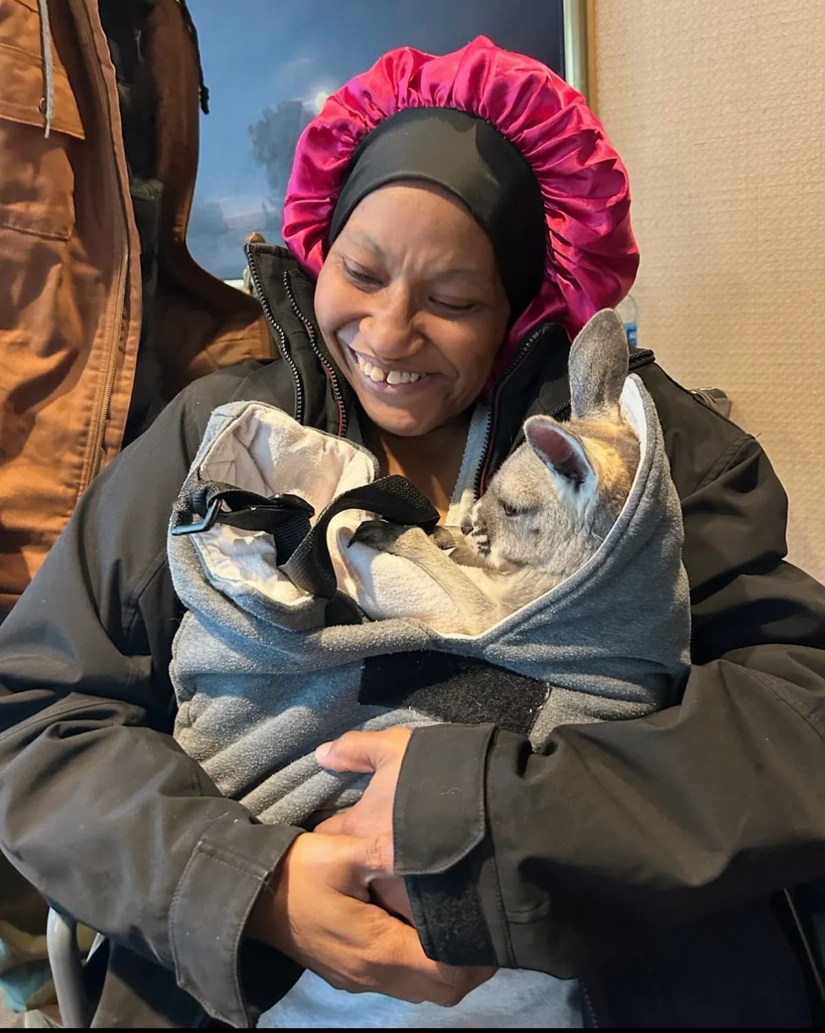 Woman cradling Sophie bundled in a jacket